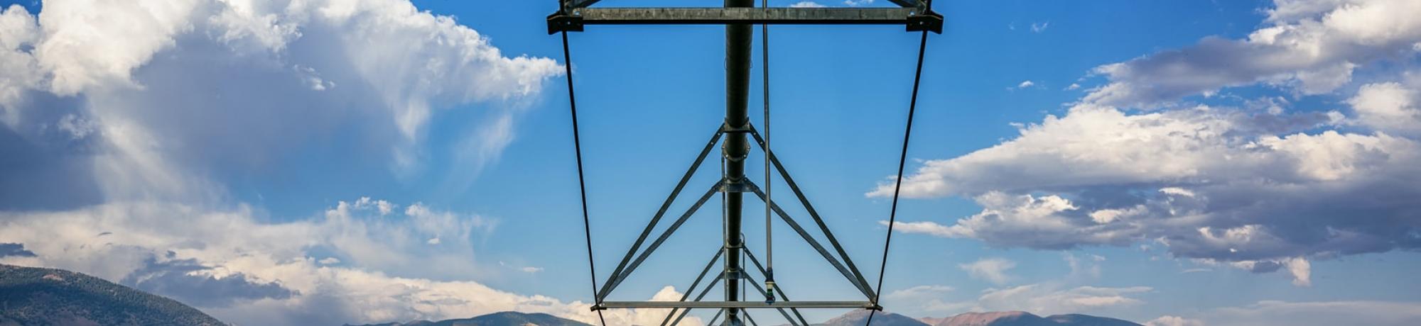 field irrigation against blue sky unsplash